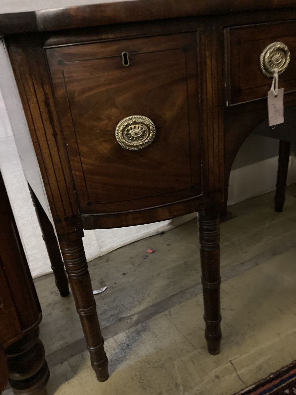 A Regency ebony inlaid mahogany bow front sideboard, width 122cm, depth 57cm, height 89cm